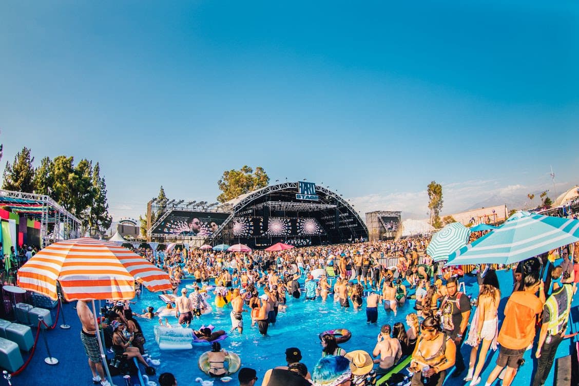 Daytime crowd around a pool in front of the HARD stage.
